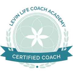 Emilee Garfield, certified life coach, smiling and looking confident in a professional setting.